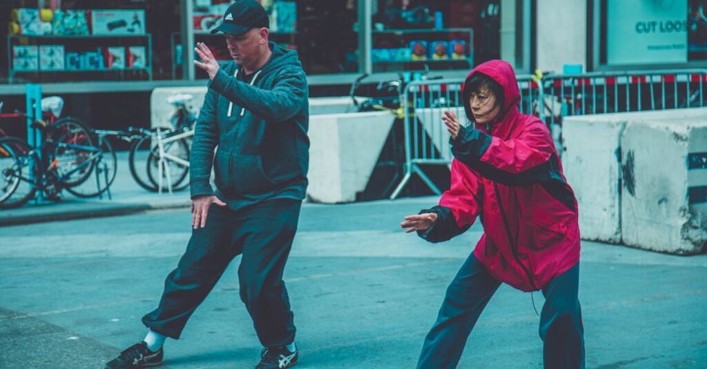 Two adults practicing martial arts on the street, showcasing fitness and focus in an urban environment.