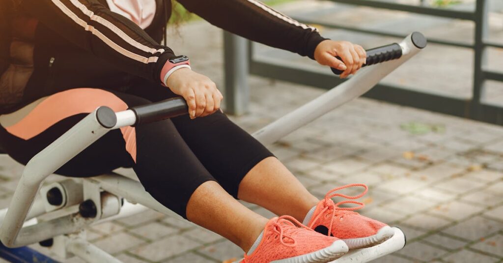 A woman in sportswear works out on outdoor fitness equipment, focusing on health and recreation.