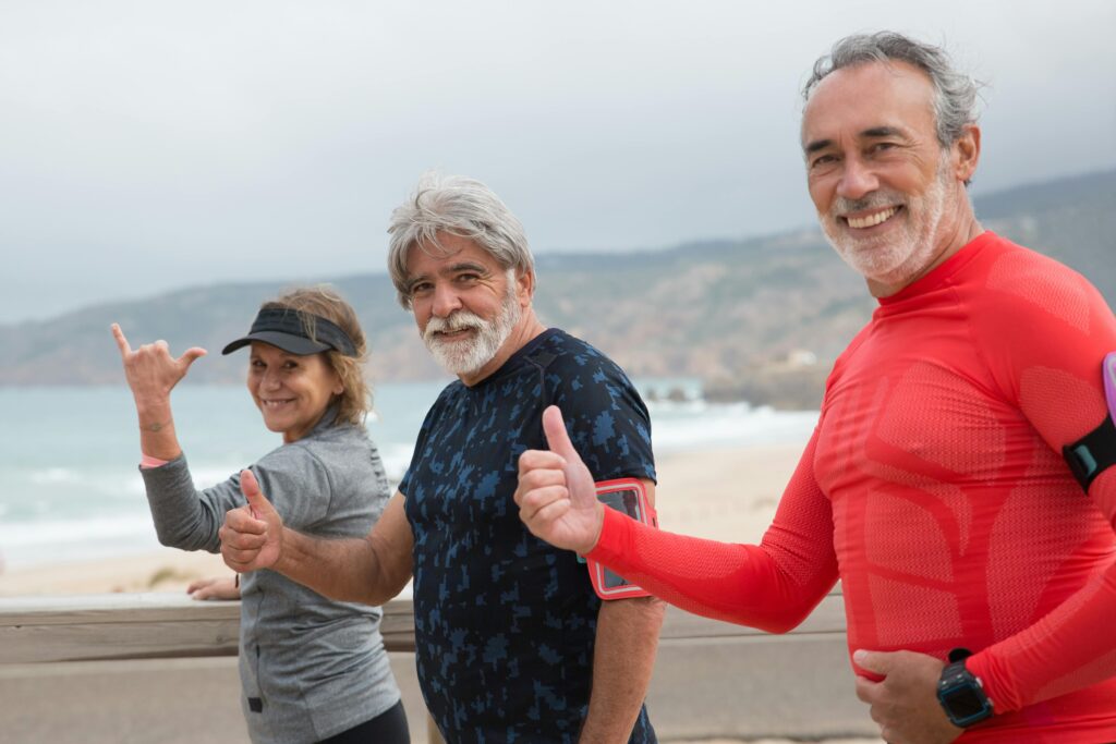 pexels-photo-8637983-8637983 Smiling senior friends exercising on a beach in Portugal, embracing a healthy lifestyle.