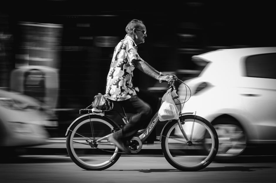 pexels-photo-2256845-2256845 A man rides a bicycle fast through city streets. Urban life captured in motion.